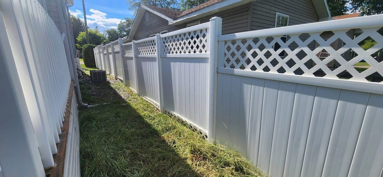 The same white vinyl fence bright white after a soft wash