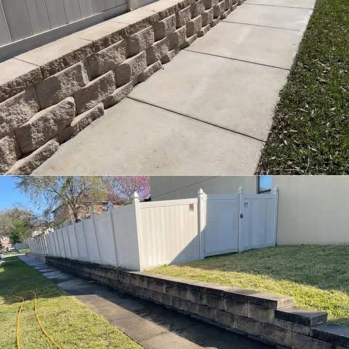 Clean sidewalk beside a block retaining wall, and a washed white vinyl fence above it